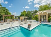 Thumbnail 1 of 34 - a swimming pool with lounge chairs next to a house