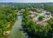 Thumbnail 21 of 34 - an aerial view of a flooded neighborhood with trees and a river
