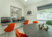 Thumbnail 5 of 34 - a conference room with a round table and orange chairs