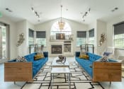 Thumbnail 2 of 34 - a living room with blue couches and a fireplace