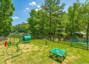 Thumbnail 14 of 34 - a park with a playground and a tennis court