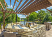 Thumbnail 9 of 34 - a patio with a grill and a table and chairs