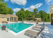 Thumbnail 12 of 34 - a swimming pool with lounge chairs next to a house