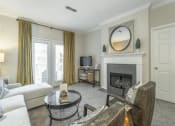 Thumbnail 4 of 25 - a living room with a couch and a fireplace