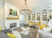 Thumbnail 1 of 25 - a living room with a fireplace and a chandelier