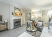 Thumbnail 5 of 25 - a living room with a fireplace and a couch