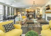 Thumbnail 15 of 25 - a living room with yellow couches and chairs and a fireplace