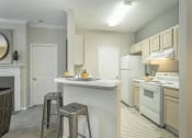 Thumbnail 7 of 25 - a kitchen with a counter top and stools