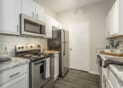Thumbnail 3 of 25 - a kitchen with stainless steel appliances and white cabinets