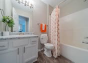 Thumbnail 12 of 25 - a bathroom with a shower and a toilet and a sink