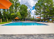 Thumbnail 2 of 35 - a swimming pool with chairs and umbrellas next to a resort style pool