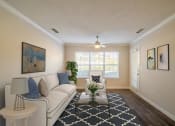 Thumbnail 3 of 35 - a living room with couches and a large window