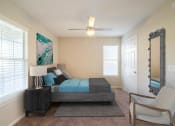 Thumbnail 9 of 35 - a bedroom with a bed and a ceiling fan