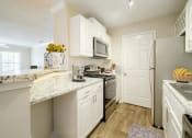 Thumbnail 8 of 35 - a kitchen with white cabinets and stainless steel appliances