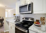 Thumbnail 1 of 35 - a kitchen with a stove and a microwave