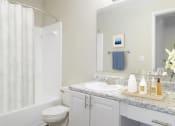 Thumbnail 11 of 35 - a bathroom with a sink and a toilet and a shower