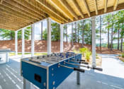 Thumbnail 20 of 35 - a foosball table in the shade of a pavilion