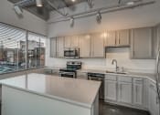 Thumbnail 16 of 41 - Kitchen With Custom Cabinetry at The Tower Apartments, Tuscaloosa, AL