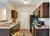 Thumbnail 6 of 34 - Black Appliances in Kitchen at Austin Place Apartments