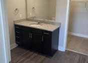 Thumbnail 13 of 29 - En-suite Bathrooms with Granite Countertops at Flats on 4th Apartments in Birmingham, AL