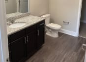 Thumbnail 12 of 29 - En-suite Bathrooms with wood floors at Flats on 4th Apartments in Birmingham, AL