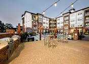 Thumbnail 24 of 38 - Outdoor Seating and grilling stations at Tapestry Bocage Apartments in Baton Rouge, LA