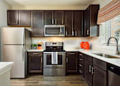 Thumbnail 21 of 38 - Kitchen with quartz countertop at Tapestry Bocage Apartments in Baton Rouge, LA