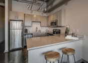 Thumbnail 4 of 41 - Fitted Kitchen With Island Dining at The Tower Apartments, Alabama, 35401