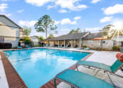 Thumbnail 10 of 24 - swimming pool with lounge chairs at Retreat at Brightside Apartments in Baton Rouge, LA