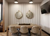 Thumbnail 17 of 22 - A dining room with a wooden table and chairs.