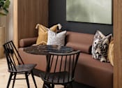 Thumbnail 9 of 22 - A modern dining area with a round table and two chairs.