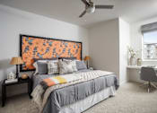 Thumbnail 11 of 22 - A bedroom with a large bed and a painting on the wall.
