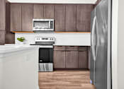 Thumbnail 50 of 55 - A modern kitchen with a stainless steel appliances and immense amount of storage.