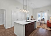 Thumbnail 12 of 55 - A modern kitchen with beautiful island that seats 3 white countertop and pendant lighting