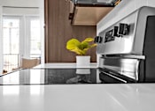 Thumbnail 5 of 55 - A modern kitchen with stainless-steel appliances and white countertops