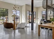 Thumbnail 40 of 55 - Lobby at Artisan Flats Apartments in Birmingham, ALrge windows and a table and chairs