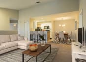 Thumbnail 33 of 34 - a living room and dining room with a couch and a table