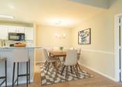 Thumbnail 22 of 34 - a dining room and kitchen with a table and chairs