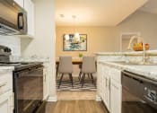 Thumbnail 25 of 34 - an open kitchen and dining room with a table and chairs