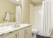 Thumbnail 24 of 34 - a bathroom with two sinks and a toilet and a shower