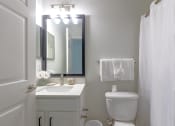 Thumbnail 14 of 25 - a white bathroom with a toilet and a sink