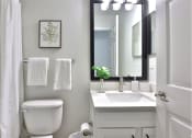 Thumbnail 12 of 25 - a small bathroom with a toilet sink and a mirror