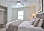Thumbnail 9 of 25 - a bedroom with a large bed and a ceiling fan