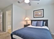 Thumbnail 11 of 25 - a bedroom with a bed and a ceiling fan