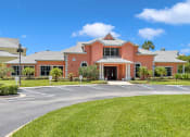 Thumbnail 30 of 35 - a large orange building with a lawn in front of it