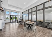 Thumbnail 13 of 21 - A modern dining room with a large table and chairs.