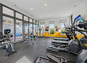 Thumbnail 15 of 21 - A gym with treadmills, exercise bikes, and other equipment.
