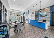 Thumbnail 11 of 21 - A modern kitchen with a dining table and chairs.