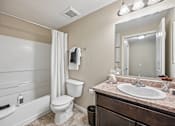 Thumbnail 8 of 21 - A bathroom with a white toilet and sink.