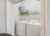 Thumbnail 10 of 21 - A laundry room with a washer and dryer.